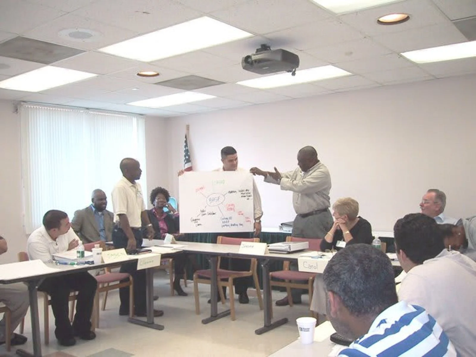 Photo of press cameras standing in a line with a white version of the Thomson Reuters logo in the middle
